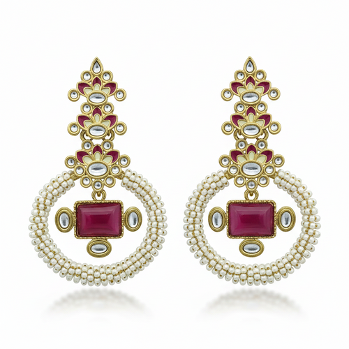 A pair of ornate gold-toned dangle earrings with white pearl-like bead loops, red rectangular and oval stones, and small clear stones, displayed on a solid green background.