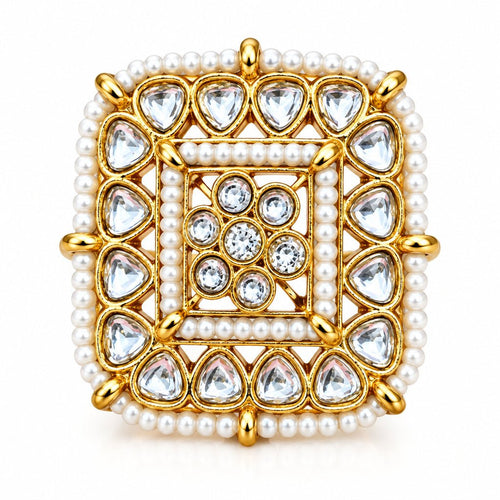 A square gold-plated ring with intricate white bead borders and clear teardrop-shaped stones, set against a solid red background.