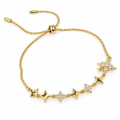 A delicate gold chain bracelet with a sliding adjustment clasp and a row of star-shaped charms, some embellished with clear rhinestones, displayed on a white surface with a dark red fabric accent.