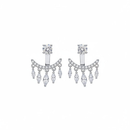 Silver earrings with dangling crystals on a beige surface
